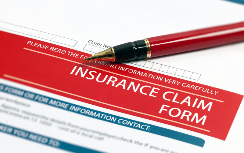 A red pen rests on top of an insurance claim form, with the form’s title—highlighted in a red banner—indicating its connection to Restoration Services, and additional instructions visible above and below.